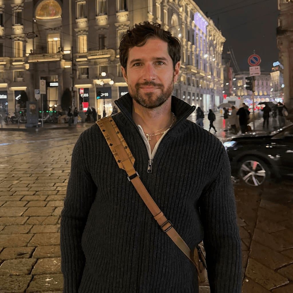 A confident, well-dressed man out in the city.