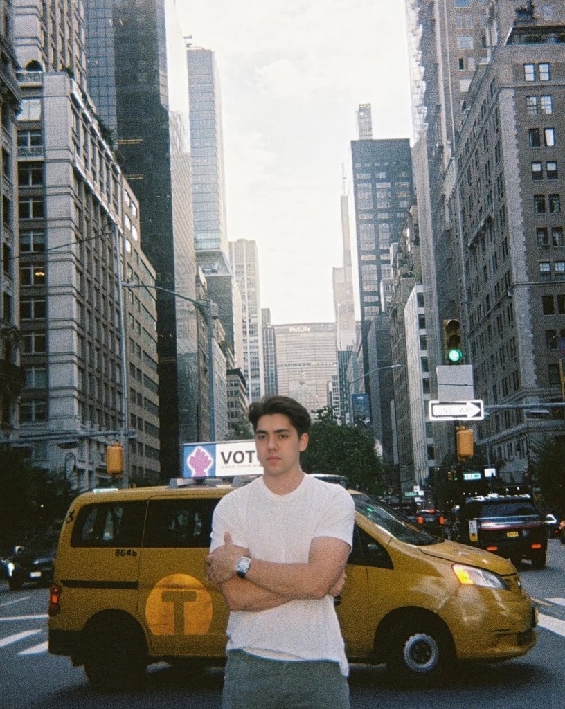 A confident man standing on a New York City street.
